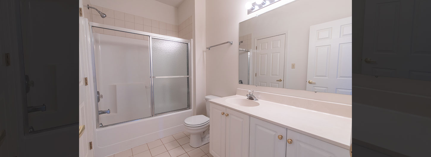 Master Bath with white cabinetry and glass shower doors